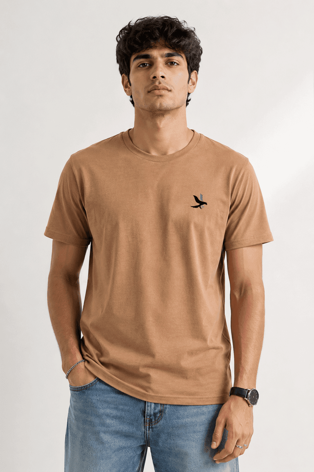 Model wearing the Beige Signature Eagle regular-fit T-shirt, front view with the eagle chest mark