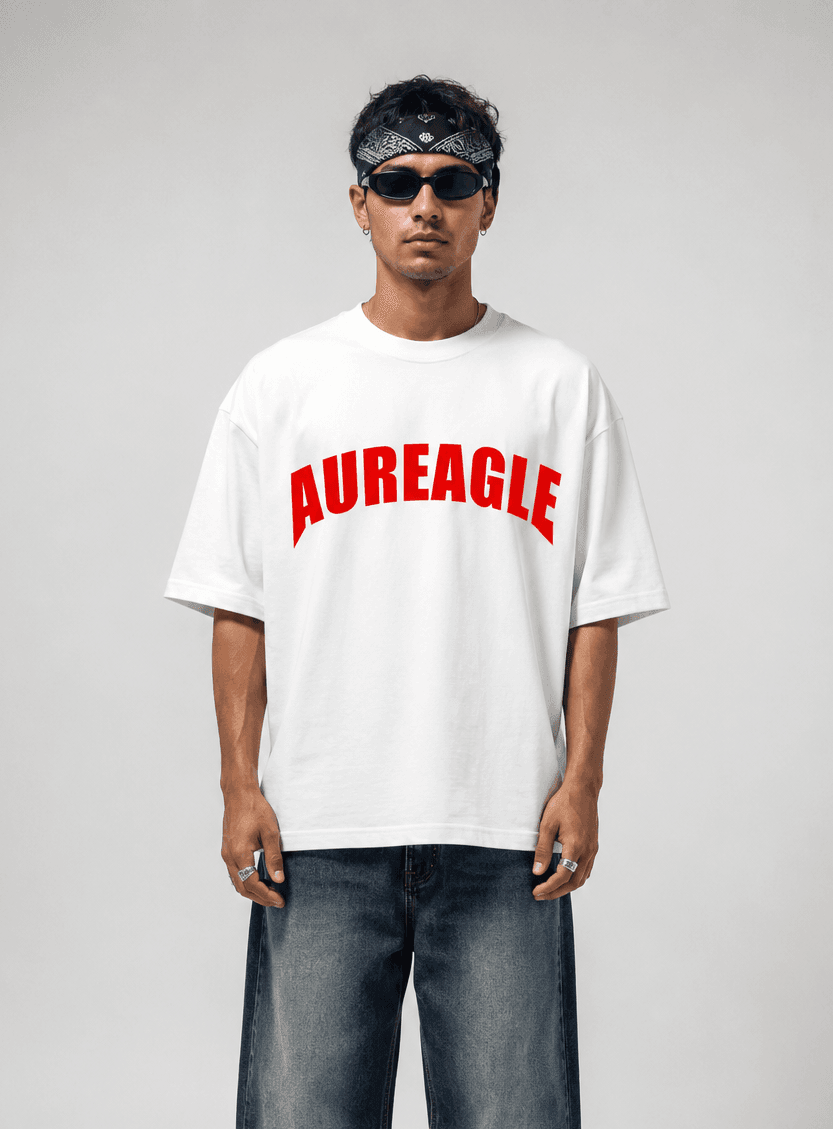 Model wearing the white Apex Eagle Oversized Tee with a red arched AUREAGLE chest print