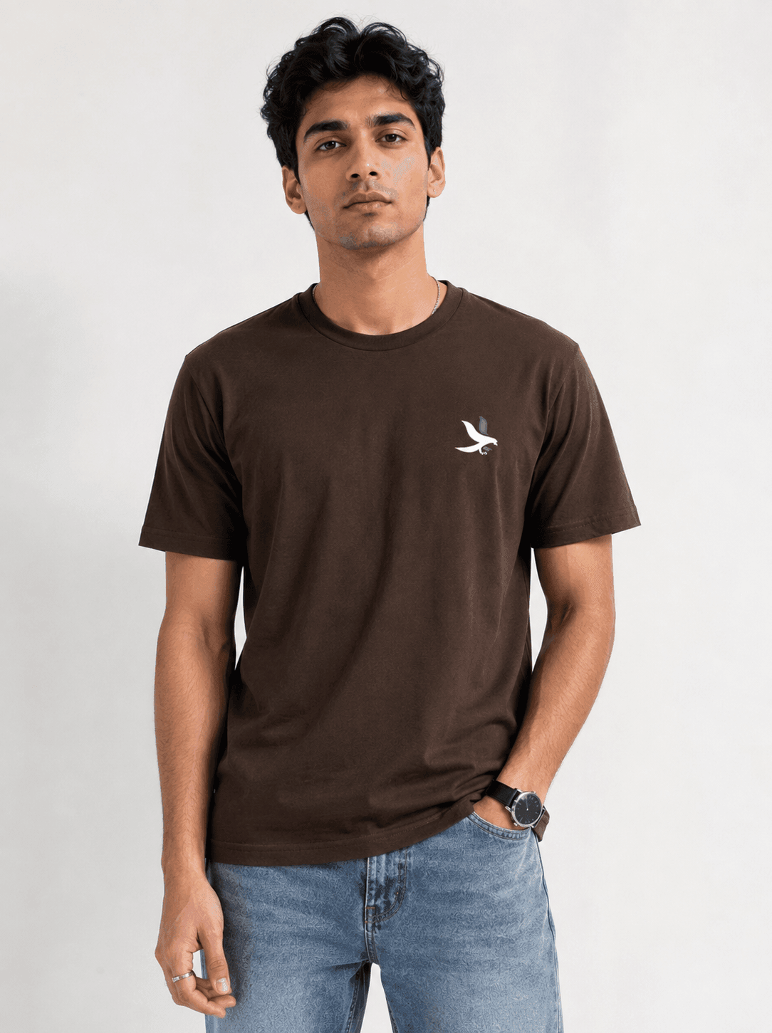 Model wearing the Chocolate Brown Signature Eagle regular-fit T-shirt, front view with the eagle chest mark