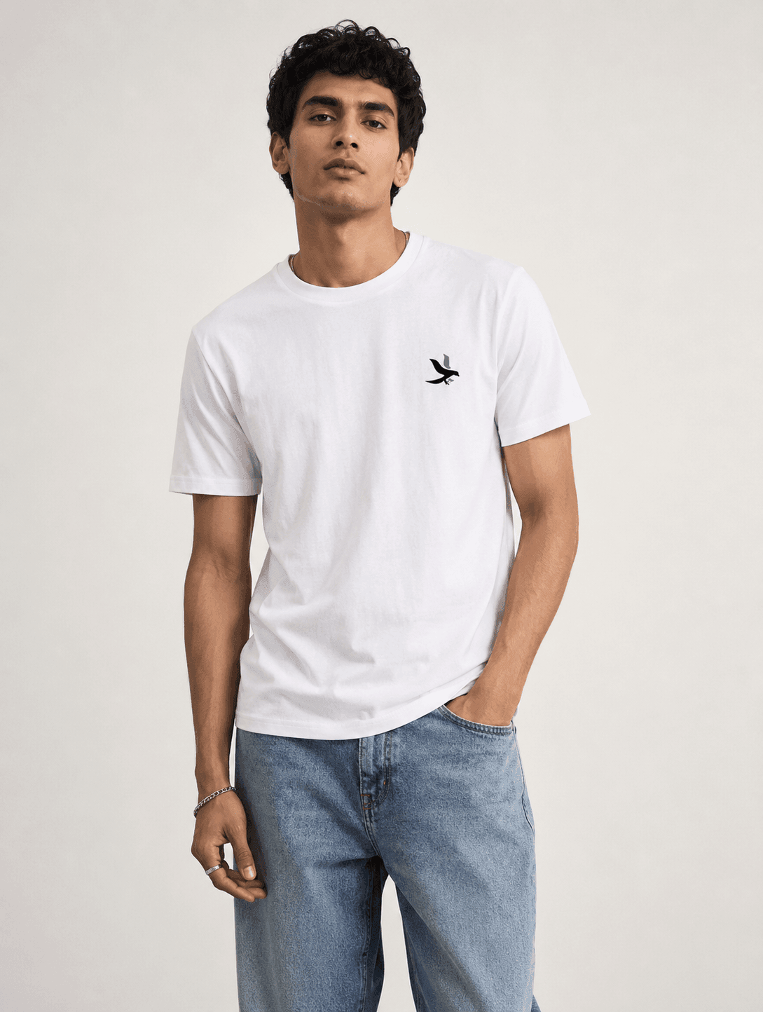 Model wearing the White Signature Eagle regular-fit T-shirt, front view with the eagle chest mark