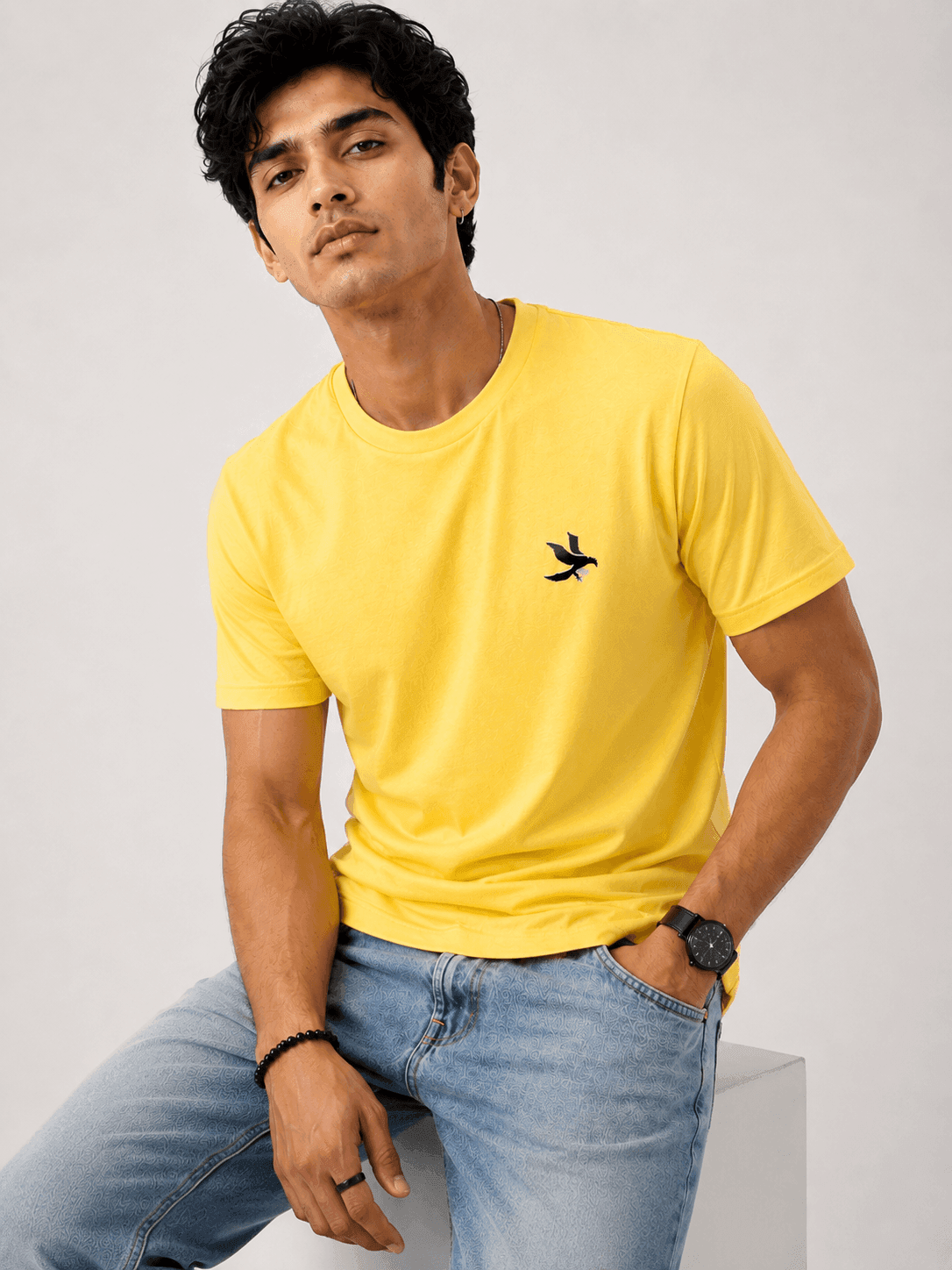 Model wearing the Yellow Signature Eagle regular-fit T-shirt, front view with the eagle chest mark