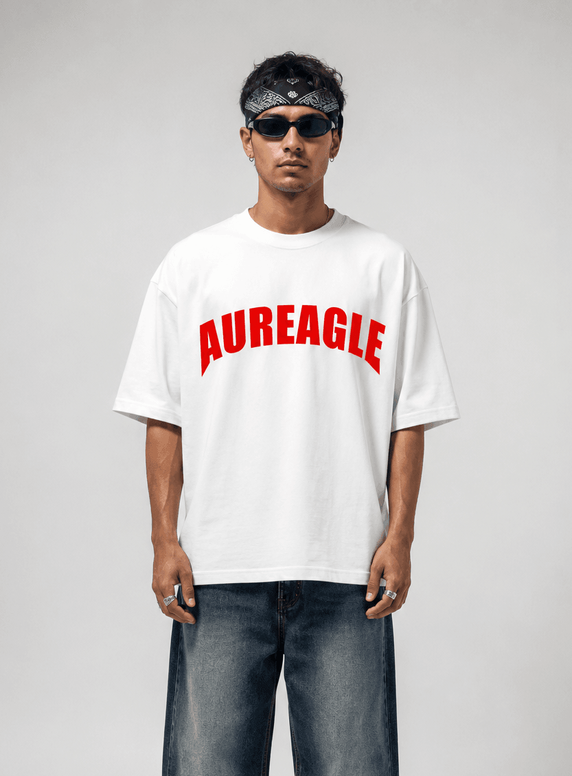 Model wearing the white Apex Eagle Oversized Tee with a red arched AUREAGLE chest print