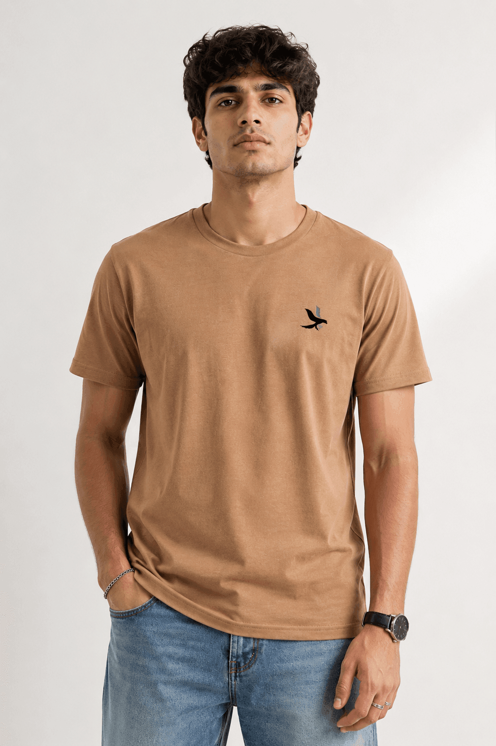 Model wearing the Beige Signature Eagle regular-fit T-shirt, front view with the eagle chest mark