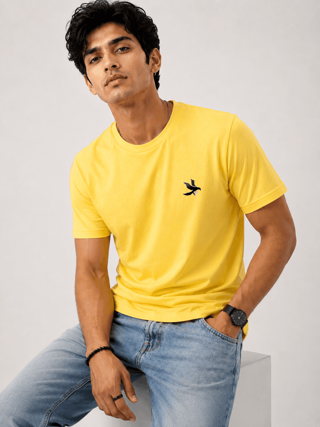 Model wearing the Yellow Signature Eagle regular-fit T-shirt, front view with the eagle chest mark